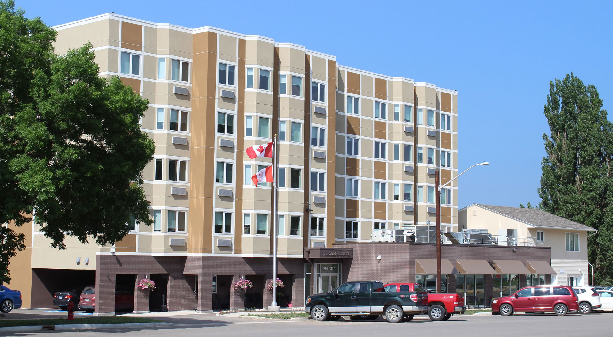 Neepawa Kinsmen Kourt II building as seen front the front. Five storey building in tones of brown and beige.