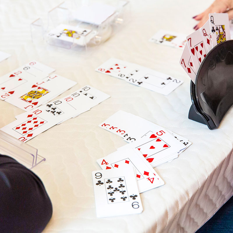 Playing canasta (card game). Cards are displayed on the table in runs.